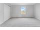 Bedroom features a closet, plush carpeting, and a window with a view at 9568 Starling Loop, Leesburg, FL 34788