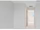 Bright hallway with carpet and white walls leads to a bedroom at 9568 Starling Loop, Leesburg, FL 34788