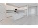Modern kitchen with white cabinets, granite countertops, stainless steel appliances, and tile flooring throughout at 9568 Starling Loop, Leesburg, FL 34788