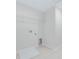 Laundry room featuring tile floors, laundry connections, and wire rack shelving at 9568 Starling Loop, Leesburg, FL 34788