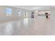 Bright and airy living room with tile flooring, abundant natural light, and open floor plan to the kitchen at 9568 Starling Loop, Leesburg, FL 34788