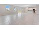Bright and airy living room with tile flooring, abundant natural light, and open floor plan to the kitchen at 9568 Starling Loop, Leesburg, FL 34788