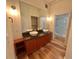 Bathroom featuring double sink vanity, granite counters, wood cabinetry, and a walk-in shower at 10 N Summerlin Ave # 25, Orlando, FL 32801
