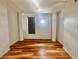 This bedroom features hardwood floors, bright white walls, and a window with a shade at 10 N Summerlin Ave # 25, Orlando, FL 32801