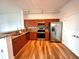 Modern kitchen featuring stainless steel appliances, wood cabinets, granite counters, and wood floors at 10 N Summerlin Ave # 25, Orlando, FL 32801