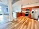 Modern kitchen with stainless steel appliances, wood cabinets, granite counters, and wood floors at 10 N Summerlin Ave # 25, Orlando, FL 32801