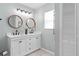 Bright bathroom with double sinks, contemporary lighting, and ample counter space at 11005 Cypress Leaf Dr, Orlando, FL 32825