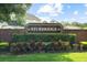 The Sturbridge brick sign is surrounded by lush landscaping and green grass in a residential neighborhood at 11005 Cypress Leaf Dr, Orlando, FL 32825