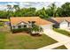 Charming single-story home with a well-manicured lawn, lovely landscaping, and a two-car garage at 11005 Cypress Leaf Dr, Orlando, FL 32825