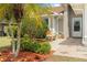 Inviting front porch with beautiful landscaping, a cozy bench, and stylish decorative touches at 11005 Cypress Leaf Dr, Orlando, FL 32825