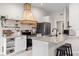 Kitchen featuring white cabinets, stainless steel appliances, granite countertops, and a breakfast bar at 11005 Cypress Leaf Dr, Orlando, FL 32825