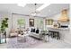 Bright living room featuring a stylish sofa, modern decor, skylights, and an open floorplan at 11005 Cypress Leaf Dr, Orlando, FL 32825