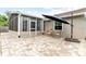 Backyard patio with a set of wicker chairs and a sun umbrella at 11005 Cypress Leaf Dr, Orlando, FL 32825