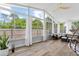 A well-lit sunroom featuring large windows that provide ample natural light, complementing the open layout and light-colored floors at 11005 Cypress Leaf Dr, Orlando, FL 32825