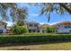 Beautiful backyard with a lush green hedge and trees outlining the black metal fence at 11139 Camden Park Dr, Windermere, FL 34786