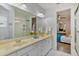 Bathroom with double sinks and a large mirror, complemented by a view into the bedroom at 11139 Camden Park Dr, Windermere, FL 34786