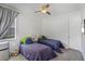Bright bedroom featuring two beds, ceiling fan, and a window providing plenty of natural light at 11139 Camden Park Dr, Windermere, FL 34786