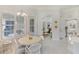 Open-concept home with breakfast nook, white floors and bright, neutral decor throughout at 11139 Camden Park Dr, Windermere, FL 34786
