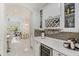 Butler pantry featuring tile floors, white cabinets and a wine refrigerator at 11139 Camden Park Dr, Windermere, FL 34786