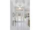 Bright foyer with decorative glass front door, tile floors, and elegant lighting fixture at 11139 Camden Park Dr, Windermere, FL 34786