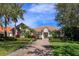 Charming one-story home with a well-manicured lawn, lush landscaping, and a brick driveway leading to the entrance at 11139 Camden Park Dr, Windermere, FL 34786