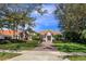 Charming one-story home with a well-manicured lawn, lush landscaping, and a brick driveway leading to the entrance at 11139 Camden Park Dr, Windermere, FL 34786