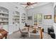 Well-lit home office featuring built-in shelving, a modern desk, and comfortable seating at 11139 Camden Park Dr, Windermere, FL 34786