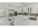 Well-lit kitchen with stainless steel appliances, white cabinets, and a convenient island at 11139 Camden Park Dr, Windermere, FL 34786