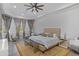 Bright main bedroom boasts natural light, soft decor, and a cozy sitting area at 11139 Camden Park Dr, Windermere, FL 34786
