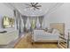 Spacious main bedroom with sitting area, TV, tray ceilings, and soft, neutral tones at 11139 Camden Park Dr, Windermere, FL 34786