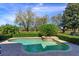 Lush backyard featuring a swimming pool, tropical plants, and manicured hedges at 11139 Camden Park Dr, Windermere, FL 34786