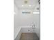Modern walk-in shower featuring sleek white tile, bench seating, and glass door at 11139 Camden Park Dr, Windermere, FL 34786