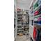 A large walk-in closet includes extensive custom shelving for shoes, folded clothing, and hanging items at 11139 Camden Park Dr, Windermere, FL 34786