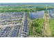 Community aerial view of neighborhood with lake access and a dense tree line at 11725 Language Way, Orlando, FL 32832