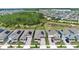 Aerial view of homes with solar panels, driveways, and landscaping in a well-planned community at 11725 Language Way, Orlando, FL 32832