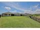 Expansive backyard featuring lush green grass and a sleek black fence at 11725 Language Way, Orlando, FL 32832