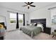 Bedroom with a black accent headboard, black out curtains, and neutral green comforter at 11725 Language Way, Orlando, FL 32832