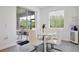 Bright breakfast nook with a modern round table, stylish chairs, and large window at 11725 Language Way, Orlando, FL 32832