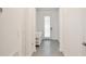 Bright hallway with gray wood-look floors leads to a front door with glass window panels at 11725 Language Way, Orlando, FL 32832