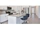 Modern kitchen featuring stainless steel appliances, gray countertops, and stylish breakfast bar seating at 11725 Language Way, Orlando, FL 32832