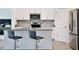 Modern kitchen featuring stainless steel appliances, gray countertops, and stylish bar stools at 11725 Language Way, Orlando, FL 32832