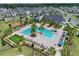 Community pool area, including a splash pad, lounge chairs, umbrellas, and a playground at 11725 Language Way, Orlando, FL 32832