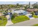 Wide aerial view of a single-story home with metal roof, lush lawn, and mature landscaping at 120 Sand Dunes Dr, Ormond Beach, FL 32176