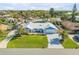 High aerial view of a single-story home with lush lawn and tropical landscaping at 120 Sand Dunes Dr, Ormond Beach, FL 32176