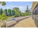 Landscaped backyard featuring a brick patio and garden wall at 120 Sand Dunes Dr, Ormond Beach, FL 32176