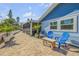 Brick patio with blue seating and partial view of the house at 120 Sand Dunes Dr, Ormond Beach, FL 32176