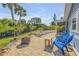 Backyard with brick patio, firepit, and blue outdoor seating set at 120 Sand Dunes Dr, Ormond Beach, FL 32176