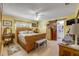 Warm and inviting bedroom with yellow walls and en suite bathroom behind wooden door at 120 Sand Dunes Dr, Ormond Beach, FL 32176