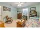 Cozy bedroom with light blue walls, vintage furniture, and a comfortable daybed at 120 Sand Dunes Dr, Ormond Beach, FL 32176