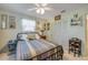Relaxing bedroom with light green walls, fan, wooden furniture and soft natural light at 120 Sand Dunes Dr, Ormond Beach, FL 32176
